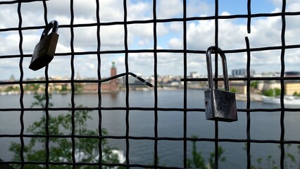 Love padlocks on a wire mesh during a scenic walk in a Stockholm street in Sweden.
