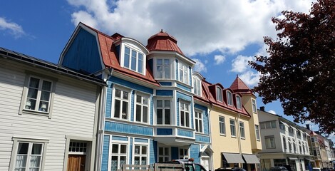 Colorful wooden buildings in a village in the Stockholm region of Sweden.