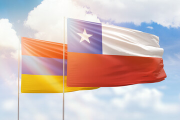 Sunny blue sky and flags of chile and armenia