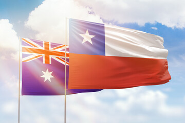 Sunny blue sky and flags of chile and australia