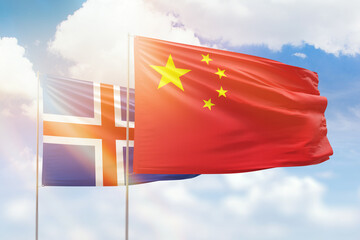 Sunny blue sky and flags of china and iceland