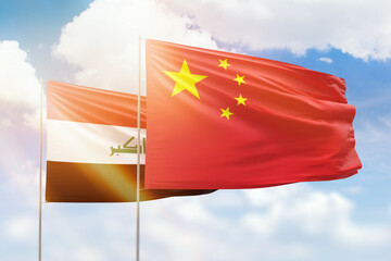 Sunny blue sky and flags of china and iraq