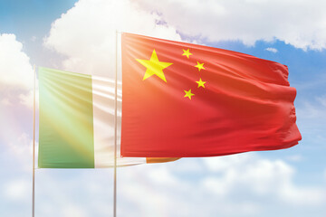 Sunny blue sky and flags of china and ireland