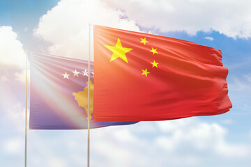 Sunny blue sky and flags of china and kosovo