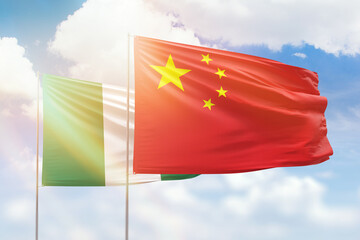 Sunny blue sky and flags of china and nigeria