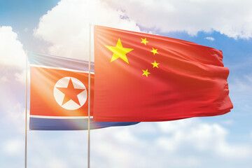 Sunny blue sky and flags of china and north korea