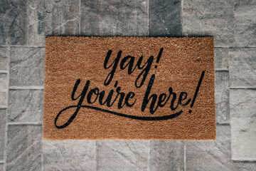 You're here door mat on a paver patio
