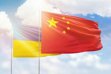 Sunny blue sky and flags of china and ukraine