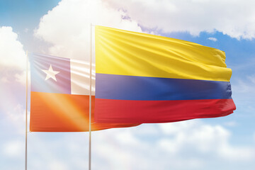 Sunny blue sky and flags of colombia and chile