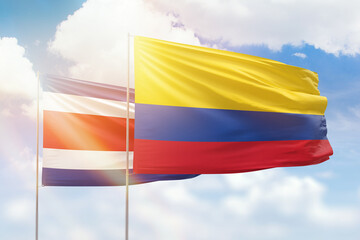 Sunny blue sky and flags of colombia and costa rica