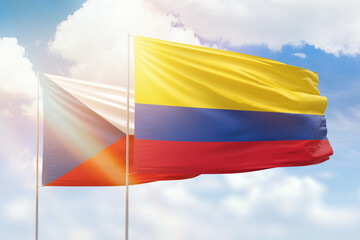 Sunny blue sky and flags of colombia and czechia