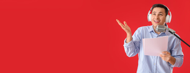 Male radio presenter with microphone on red background with space for text
