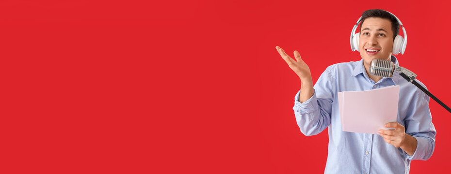 Male radio presenter with microphone on red background with space for text