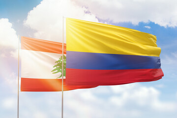 Sunny blue sky and flags of colombia and lebanon