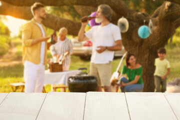 Empty wooden table at barbecue party outdoors