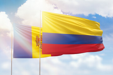 Sunny blue sky and flags of colombia and moldova
