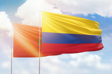 Sunny blue sky and flags of colombia and morocco