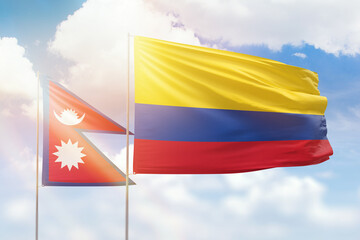 Sunny blue sky and flags of colombia and nepal