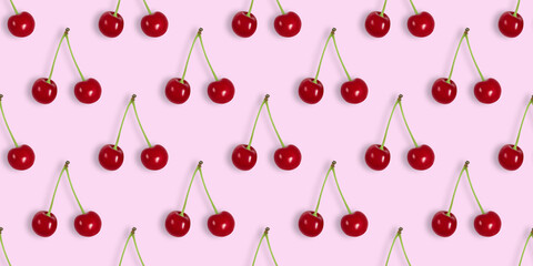 Seamless pattern with cherries on pink background. Cherry seamless textures for design. Berry summer background. Top view, flat lay. Banner.