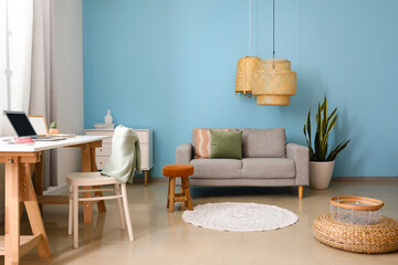Fototapeta na wymiar Interior of modern living room with comfortable sofa, houseplant and lamp