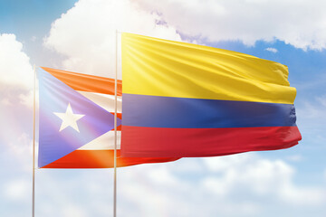 Sunny blue sky and flags of colombia and puerto rico