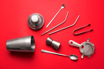 Silver bartender tools on red background