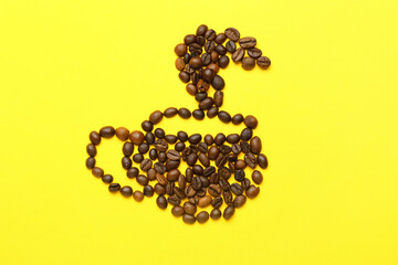Cup made of coffee beans on yellow background