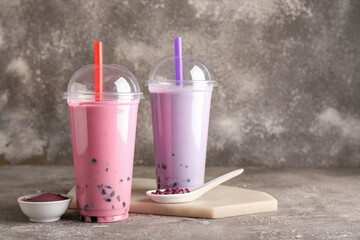 Plastic cups of tasty bubble tea on table