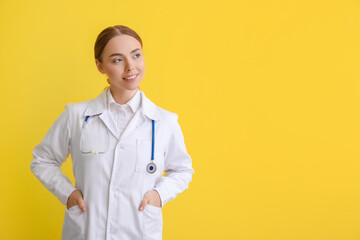 Female doctor on yellow background