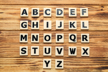 Different letters on wooden background. Alphabet concept