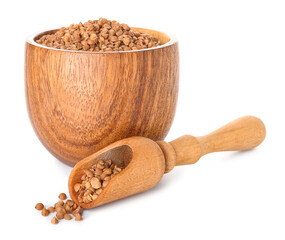 Wooden bowl and scoop with buckwheat grains on white background
