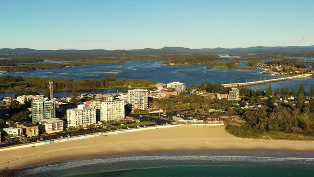 Forster beach with rock pool on waterfront of town &ndash; aerial flying 4k.
