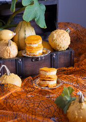 mini pumpkin cheesecakes on a background of pumpkins, autumn, orange color food