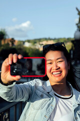 Smiling female traveler taking a selfie in the city