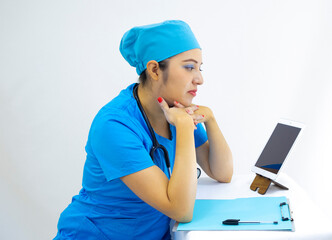 beautiful woman lab technician wearing uniform and blue surgical cap, in video call to give results, on white background