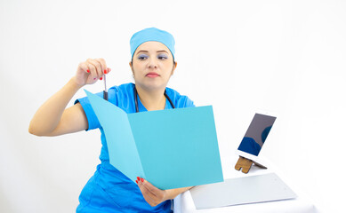 beautiful woman doctor, wearing blue uniform and blue surgical cap, stethoscope on her neck, using the tablet to show results, on white background