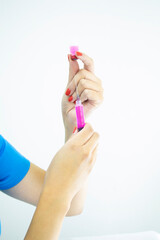 Professional laboratory technician preparing injection on white background