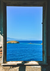 Window to the sea in an abandoned house and across the islands, the Aegean sea, Foça, Phokaia