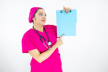 beautiful woman medical assistant, wearing uniform and pink surgical cap, stethoscope, pointing at clipboard with results, on white background