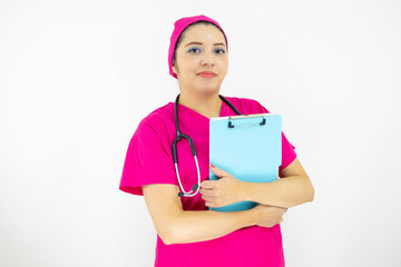 beautiful woman medical assistant, wearing uniform and pink surgical cap, stethoscope on her neck, holding clipboard with results, on white background