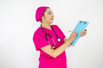 beautiful woman medical assistant, wearing uniform and pink surgical cap, stethoscope on her neck, holding clipboard with results, on white background