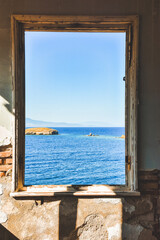 Window to the sea in an abandoned house and across the islands, the Aegean sea, Foça, Phokaia, Turkey