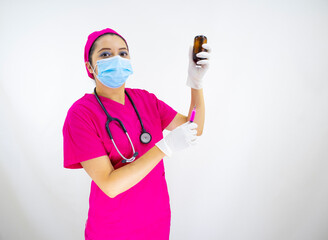beautiful woman medical assistant wearing face mask, uniform and pink surgical cap, stethoscope and latex gloves, preparing injection on white background
