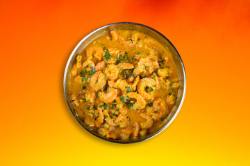 Delicious shrimp moqueca with a vivid orange background