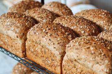 freshly baked multigrain bread loaves on cooling rack
