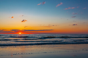 Beautiful sunrise with the sun peaking out over the ocean