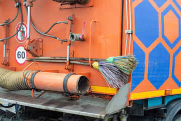 Naklejka premium Hand-held brooms on the street cleaning car