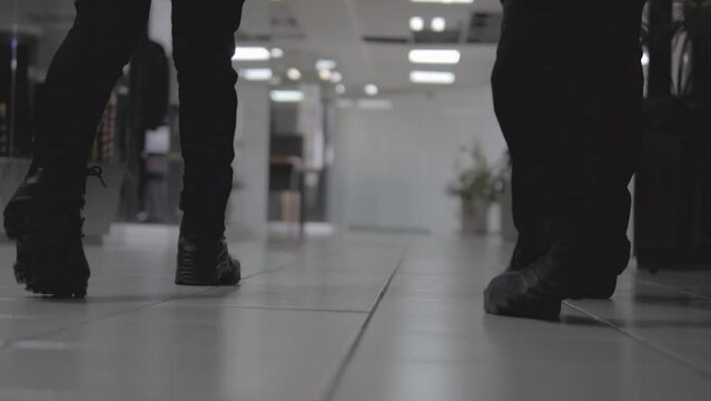 Two people walking in an office in slow motion