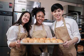 Portrait of three pastry startup partners looking at camera with a cheerful smile and proud with...