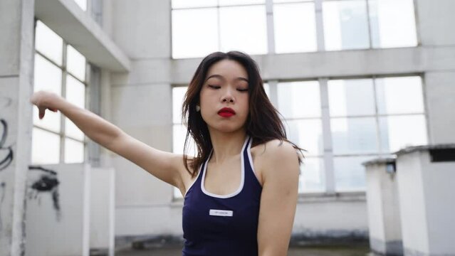 slow motion young asian woman dance on the roof in the city